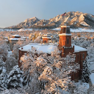 The majestic snow-covered Flatirons are a breathtaking backdrop with Old Main in the foreground. Casey A. Cass