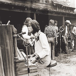 Robert Lamm plays piano with Chicago band members in the background